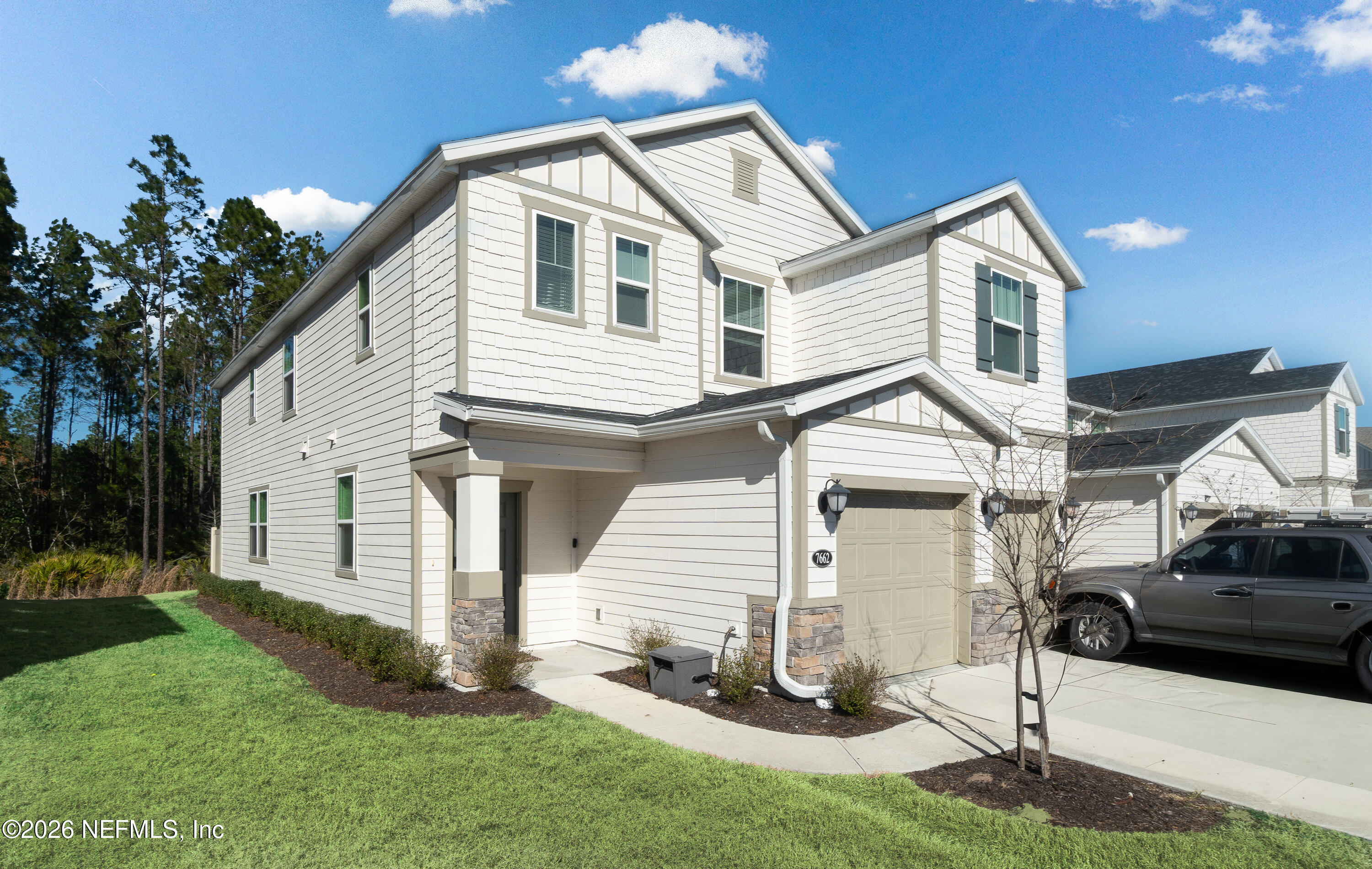 7662 Merchants Way Jacksonville, FL 32222 - Photo 3 of 32 a front view of a house with a yard