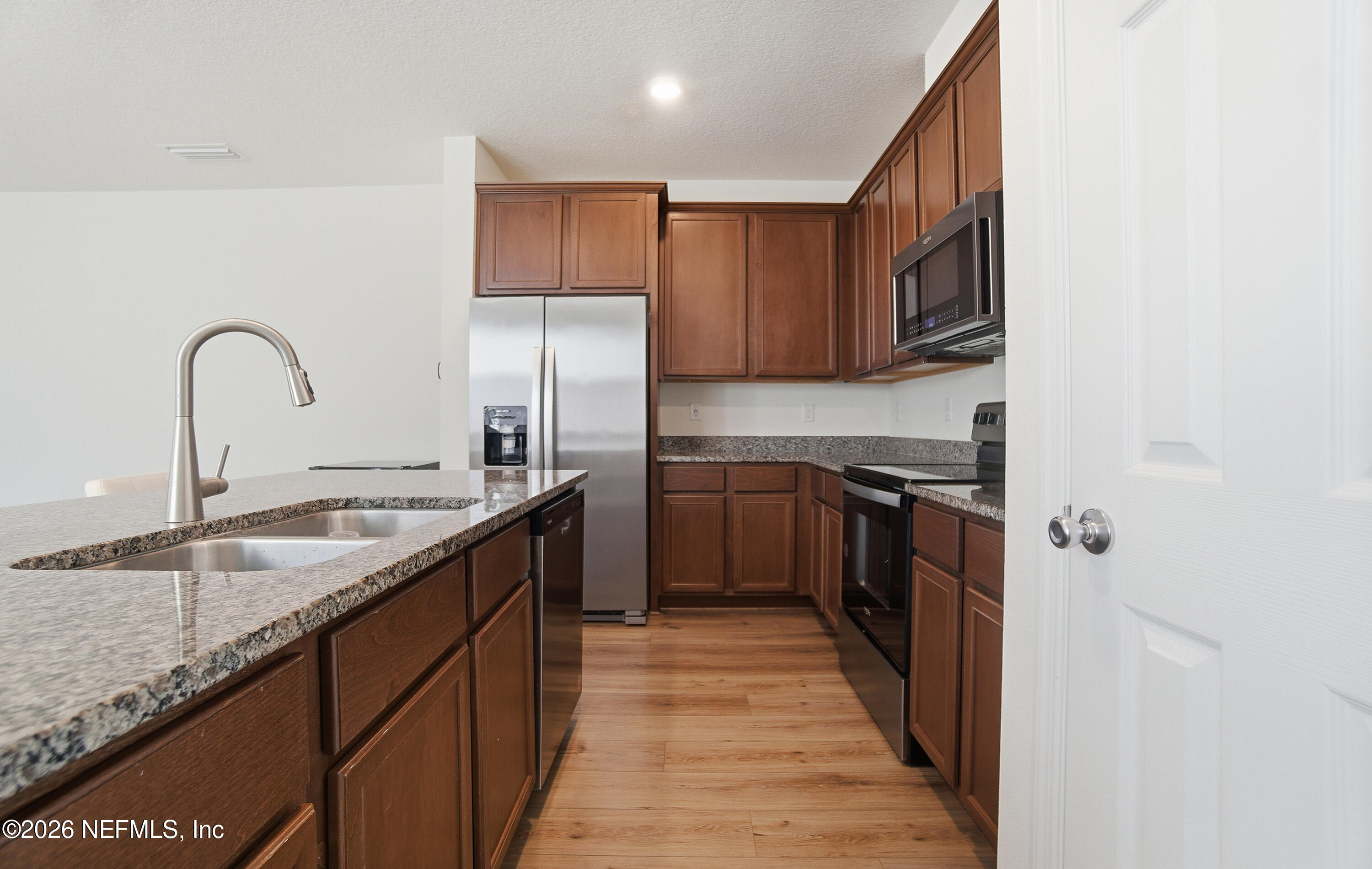 7662 Merchants Way Jacksonville, FL 32222 - Photo 6 of 32 a kitchen with kitchen island granite countertop a sink stove and refrigerator