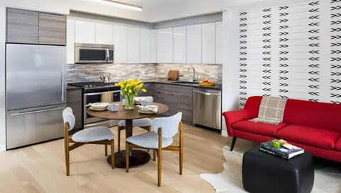 a kitchen with stainless steel appliances kitchen island granite countertop a refrigerator a stove a sink dishwasher with a dining table and chairs