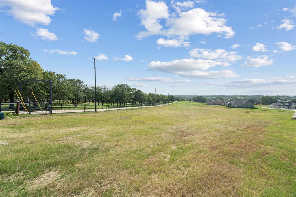 1052 North Agnes Road Springtown, TX 76082 - Photo 7 of 16 a view of a lake with a big yard