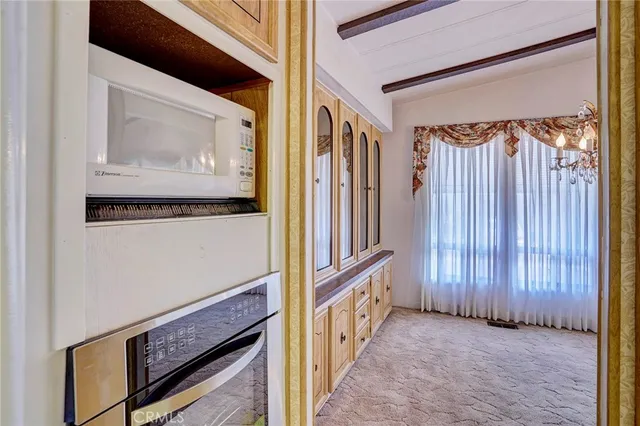 a kitchen with cabinets appliances and a window