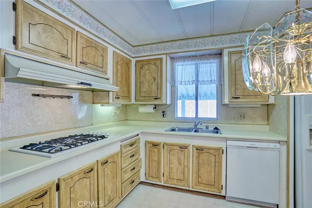 a large kitchen with cabinets and stainless steel appliances