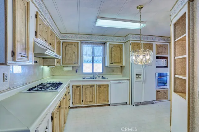 a view of a kitchen with a sink and a refrigerator