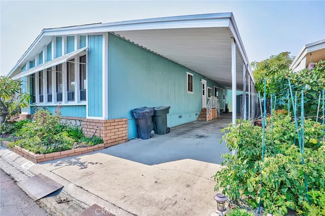 a view of a house with a small yard and plants