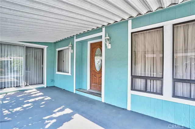 a view of a porch with a table and chairs
