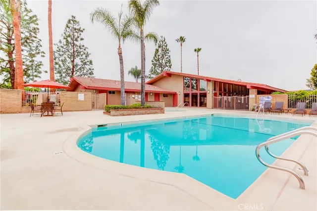 a view of a house with backyard and sitting area
