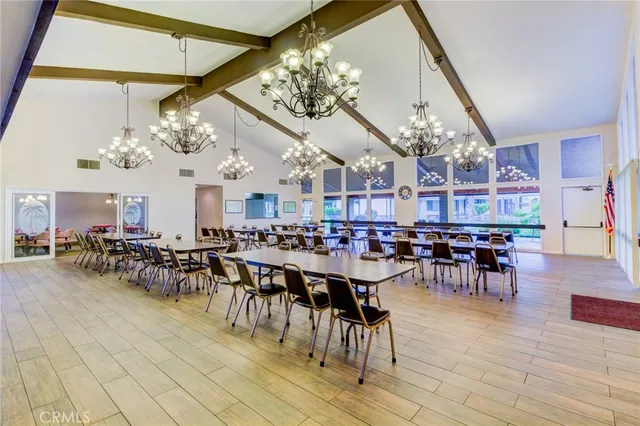 a view of a dining room with furniture and chandelier