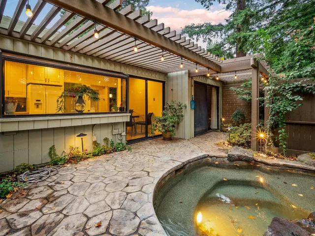 a swimming pool with outdoor seating and yard