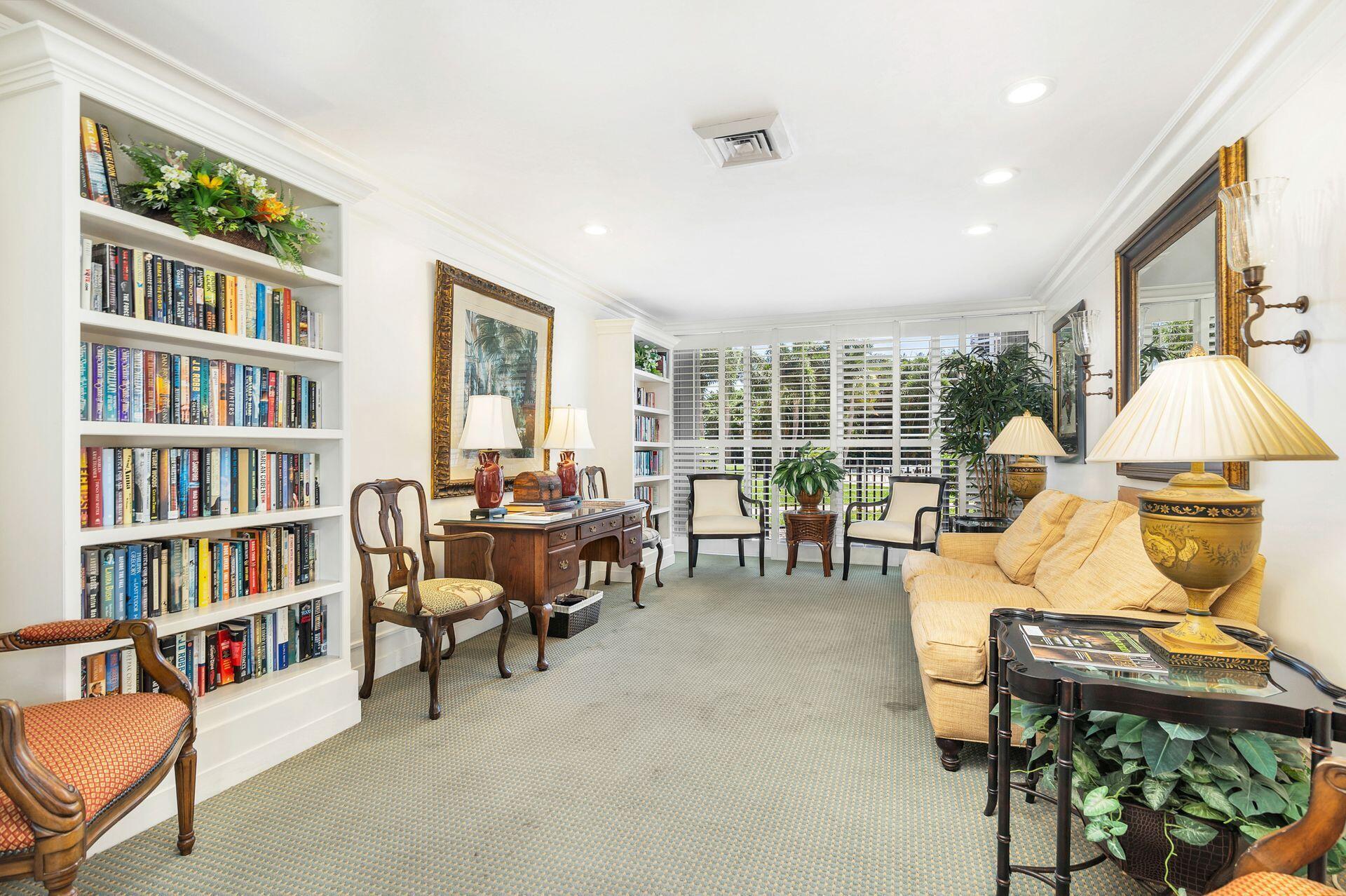 3800 Washington Road, Unit 606 West Palm Beach, FL 33405 - Photo 23 of 27 a living room with furniture and a book shelf
