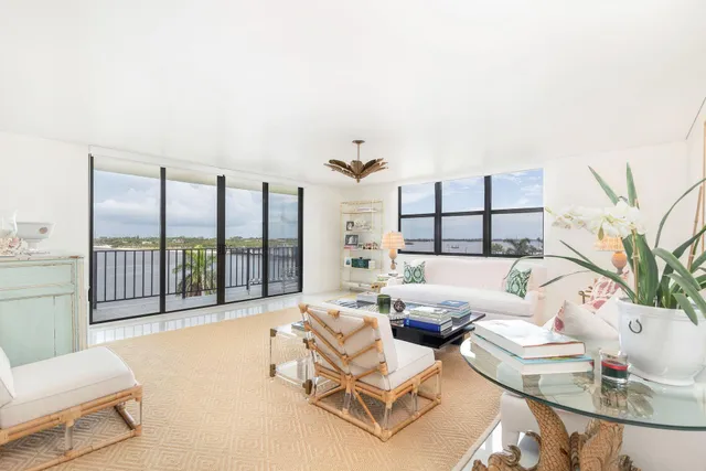 a view of a patio with couches table and chairs with wooden floor and fence