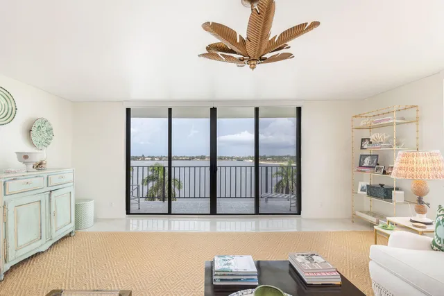 a living room with furniture and a book shelf