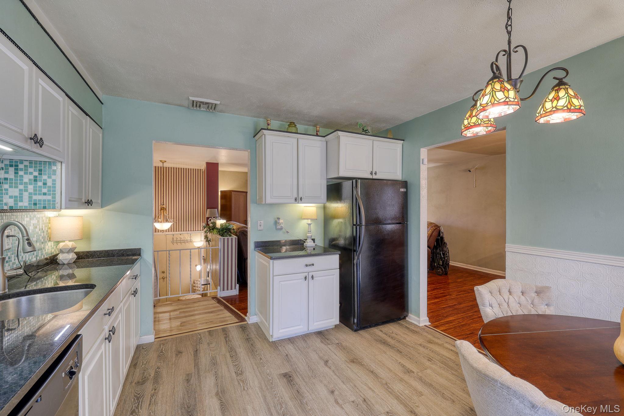 1 Townsend Street New Windsor, NY 12553 - Photo 15 of 36 a kitchen with stainless steel appliances granite countertop a refrigerator a sink dishwasher a stove and white countertops with wooden floor