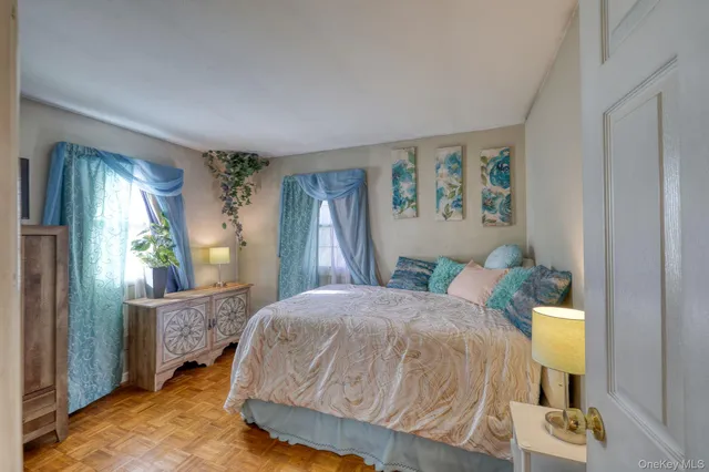 a bedroom with a bed and large windows