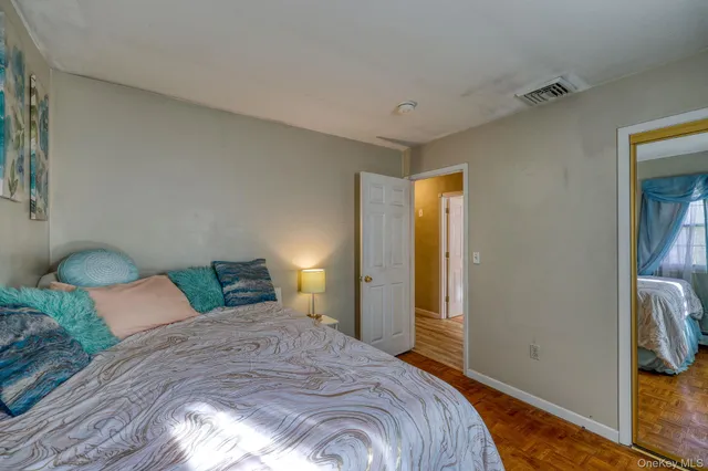 a bedroom with a bed and a lamp