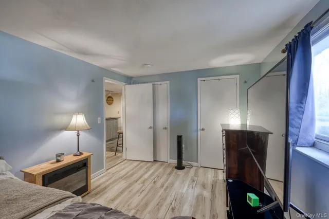 a spacious bedroom with a bed and a dresser