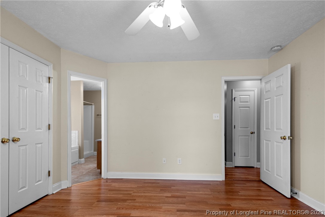 185 King Road Fayetteville, NC 28306 - Photo 13 of 24 an empty room with wooden floor and windows