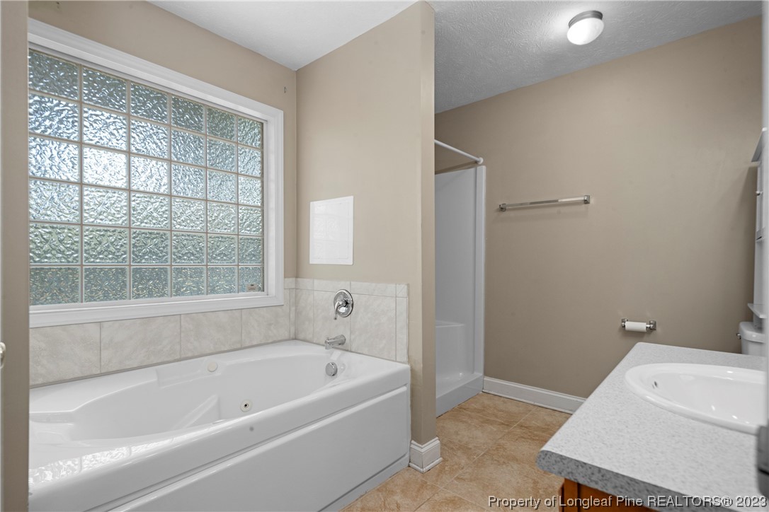 185 King Road Fayetteville, NC 28306 - Photo 14 of 24 a bathroom with a bathtub and a shower