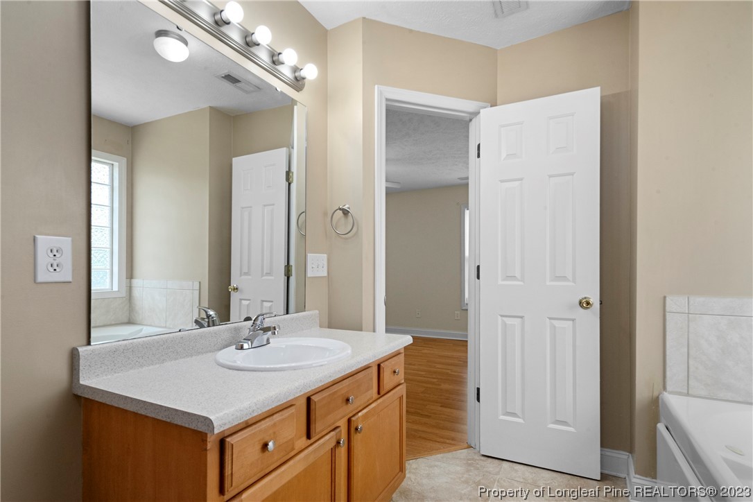 185 King Road Fayetteville, NC 28306 - Photo 16 of 24 a bathroom with a sink vanity and a mirror