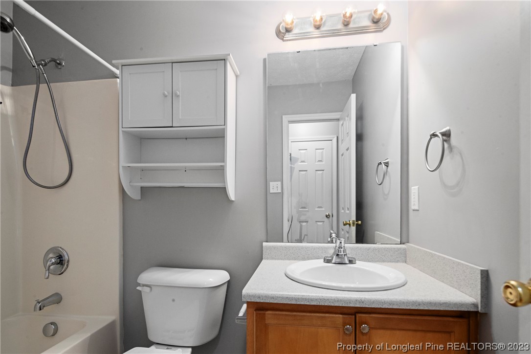 185 King Road Fayetteville, NC 28306 - Photo 9 of 24 a bathroom with a sink toilet and shower