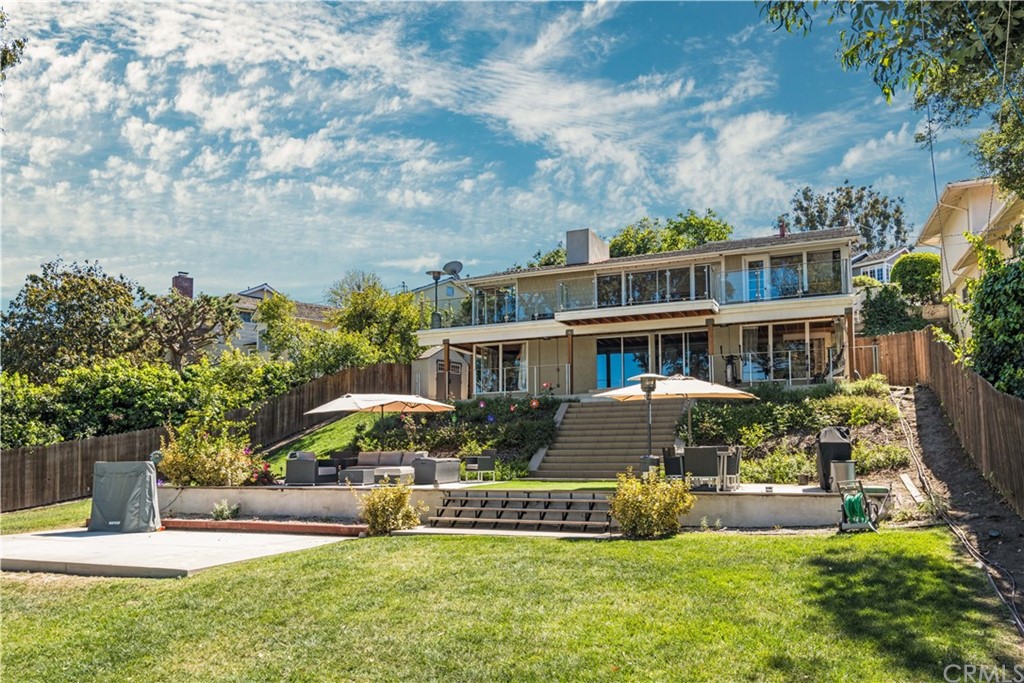 a front view of a house with a yard table and chairs