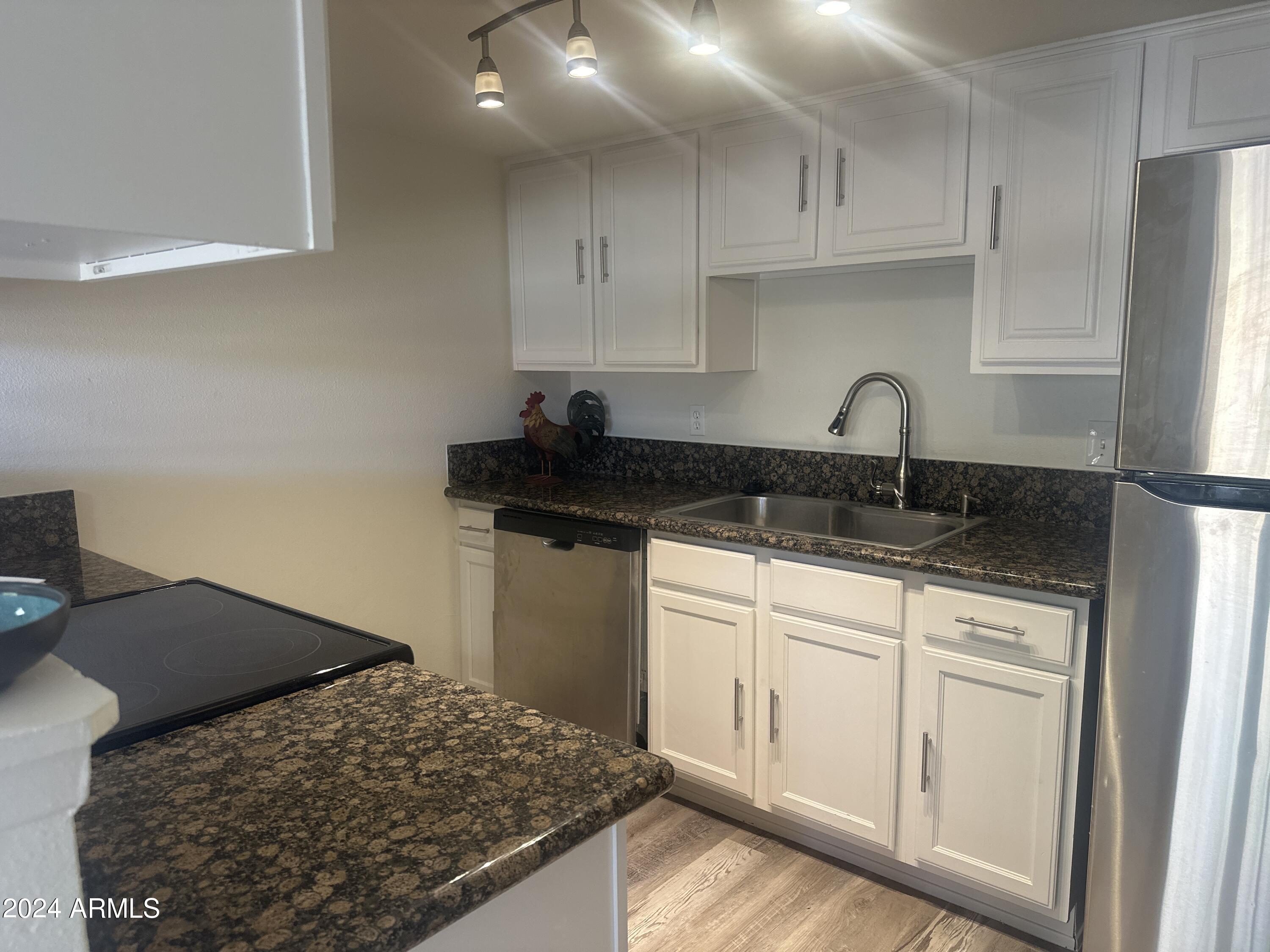 3511 East Baseline Road, Unit 1118 Phoenix, AZ 85042 - Photo 3 of 18 a kitchen with a sink and cabinets