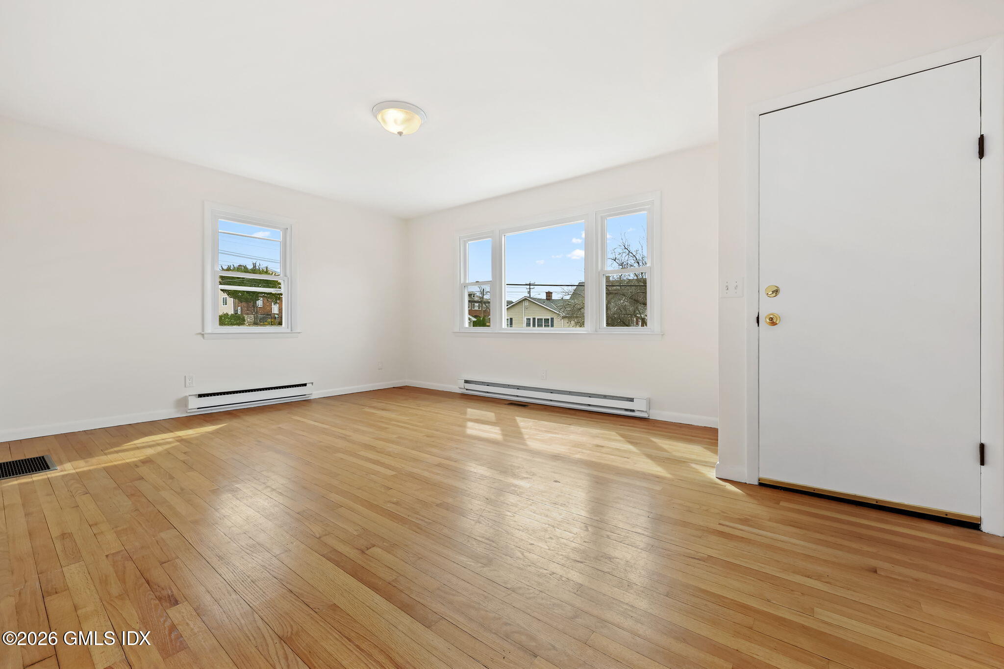 2 Grange Street Greenwich, CT 06830 - Photo 2 of 31 an empty room with wooden floor and windows