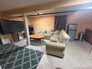 a bedroom with furniture and a mirror