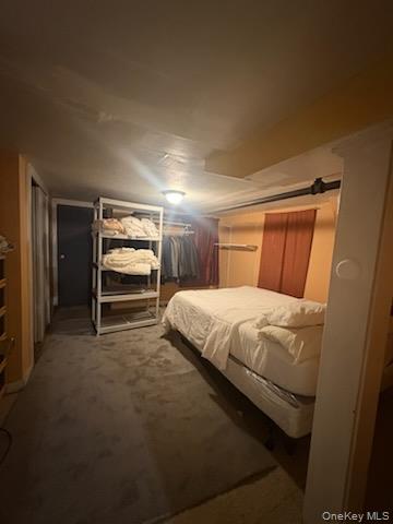 191-44 113th Road Queens, NY 11412 - Photo 28 of 31 a bed sitting in a room next to a cabinet