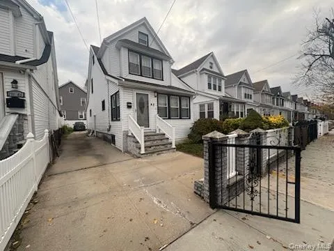 a view of a house with wooden fence