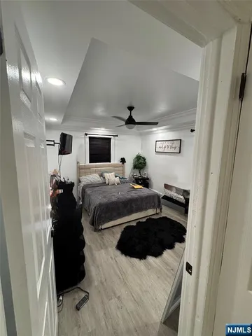 a bedroom with a bed and a television