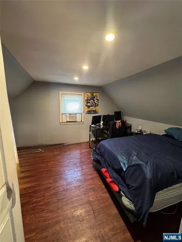 a spacious bedroom with a bed and window