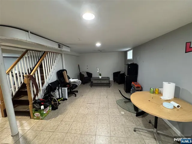 a living room with furniture and a gym machine