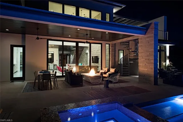 a living room with furniture with large windows