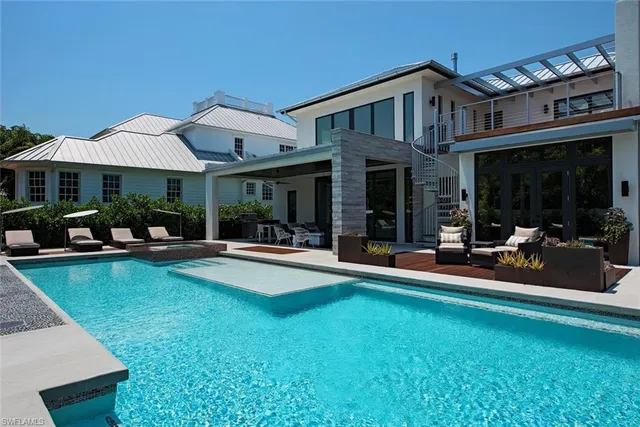 a view of a house with pool porch and chairs