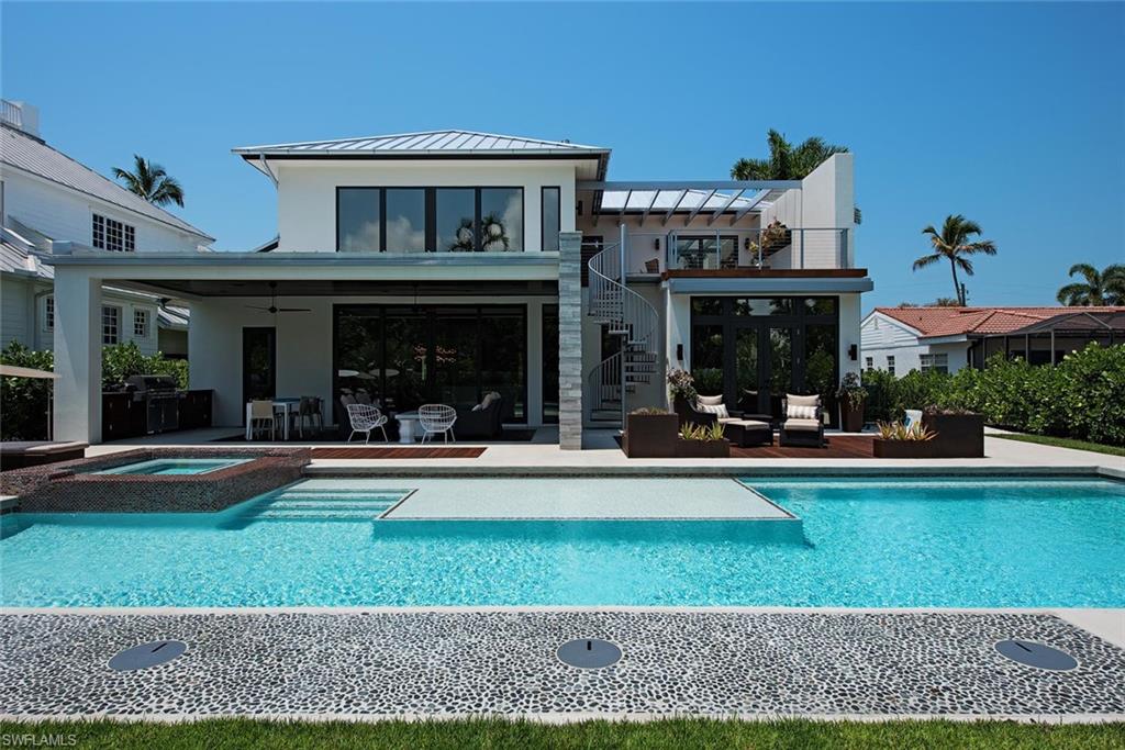 688 3rd Street North Naples, FL 34102 - Photo 18 of 33 a view of a house with a swimming pool