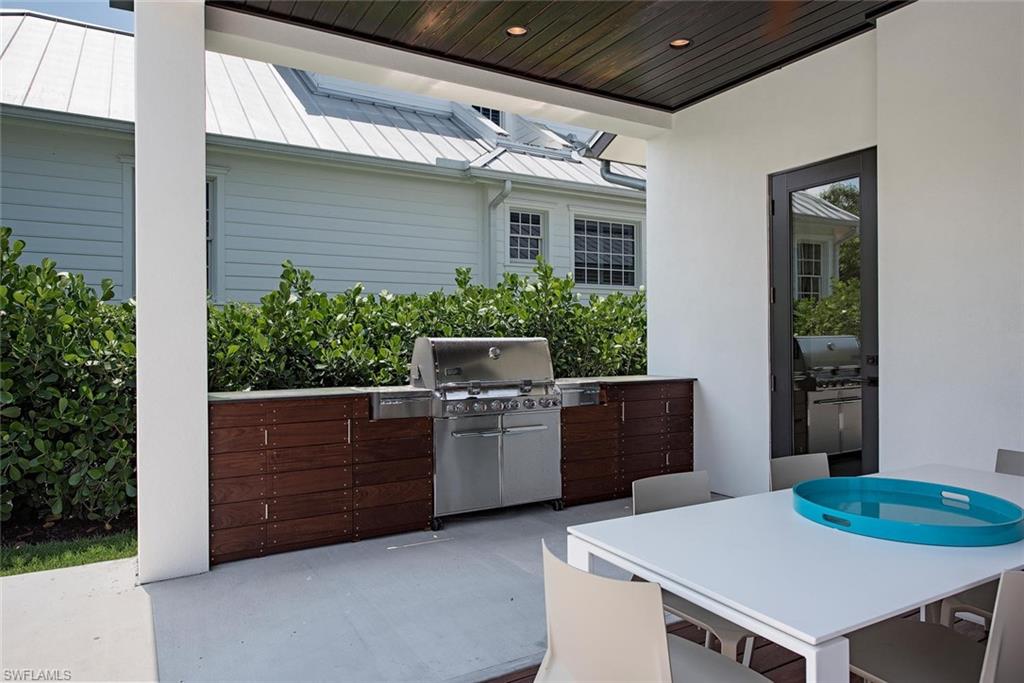 688 3rd Street North Naples, FL 34102 - Photo 20 of 33 a dinning table and chairs in the patio