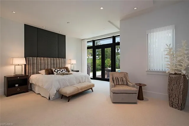 a spacious bedroom with a bed and a couch