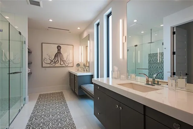 a bathroom with double vanity sink and a mirror