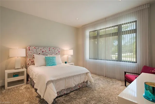 a bedroom with a bed and windows