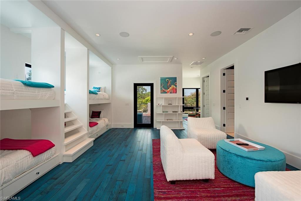 688 3rd Street North Naples, FL 34102 - Photo 30 of 33 a living room with furniture and a flat screen tv