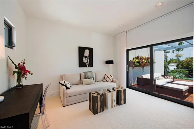 a living room with furniture large window and flat screen tv