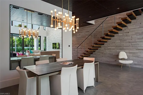 a kitchen with a table chairs and a chandelier