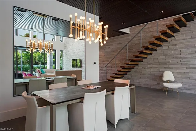 a kitchen with a table chairs and a chandelier