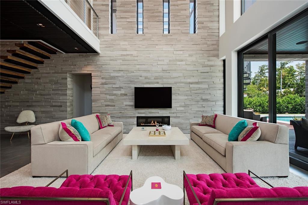 688 3rd Street North Naples, FL 34102 - Photo 7 of 33 a view of a patio with couches table and chairs with garden view