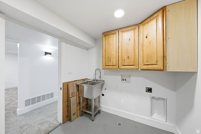 120 North 1230 E Street Springville, UT 84663 - Photo 27 of 60 Laundry area featuring upper wood cabinetry, a stainless steel utility sink, and wall-mounted plumbing for appliances