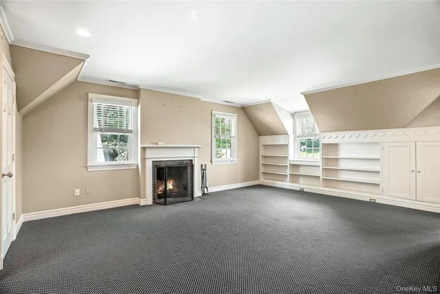 an empty room with a fireplace and window