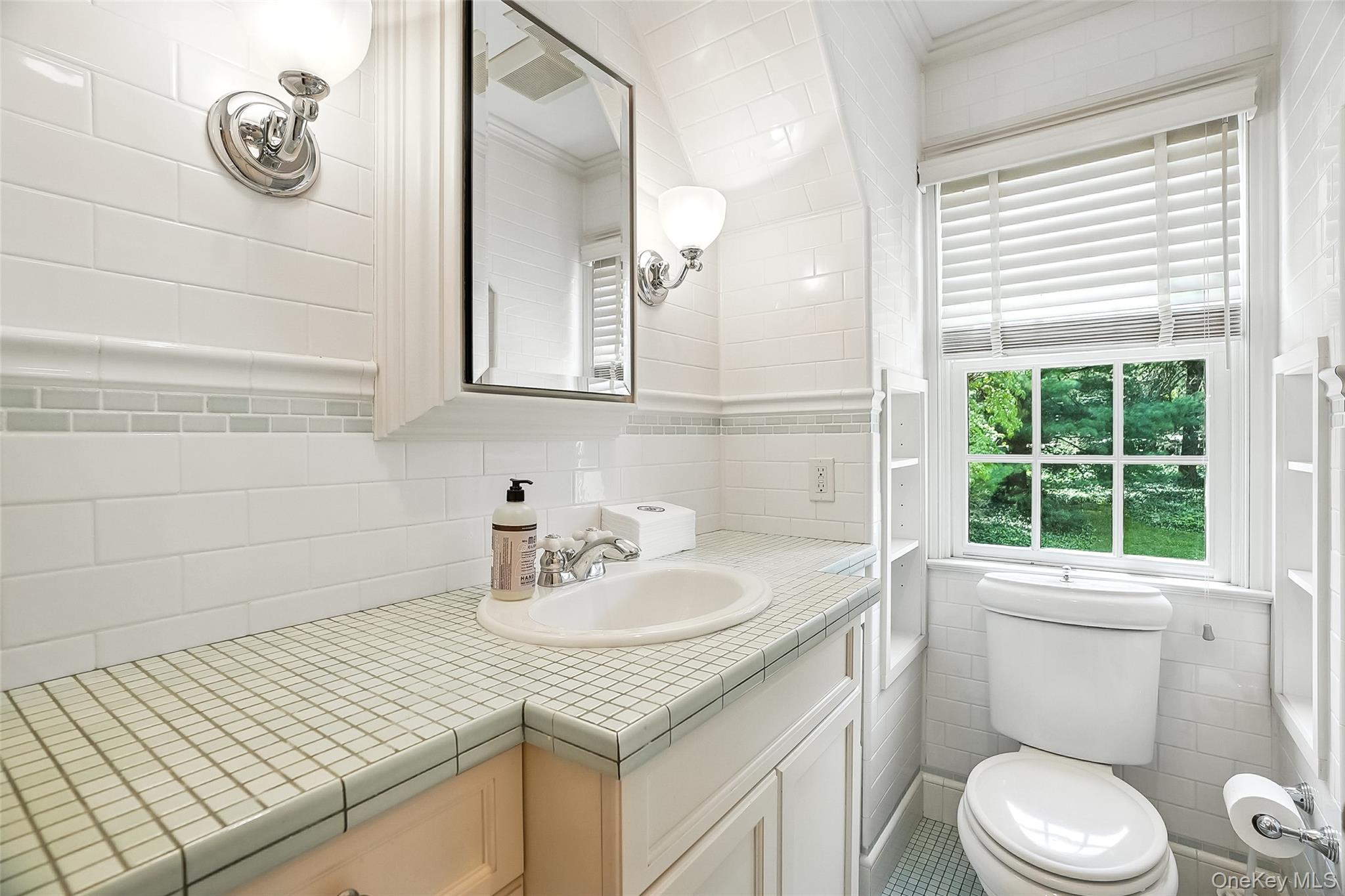 6 Club Road Rye, NY 10580 - Photo 20 of 28 a bathroom with a sink a toilet and a window