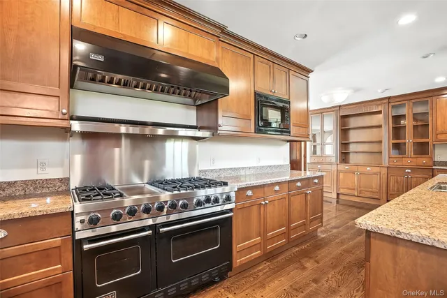 a kitchen with stainless steel appliances granite countertop a stove and a microwave