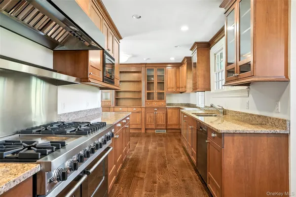 a kitchen with stainless steel appliances granite countertop a stove and a sink