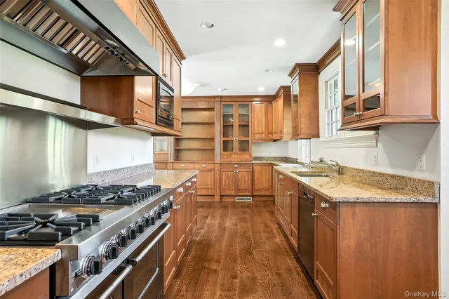 a kitchen with stainless steel appliances granite countertop a stove and a sink